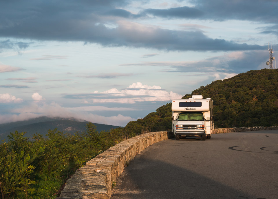 Camper with clouds behind it